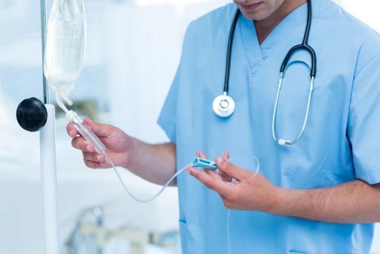 A doctor is preparing a high dose vitamin c iv drip in the iv drip clinic in London